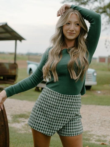 forest green long sleeve knit open back sweater top with green and white houndstooth high waist mini skort